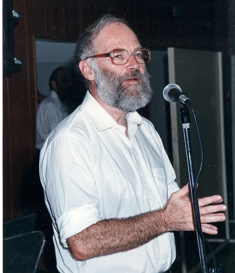 Portrait of Lee Israel speaking at a microphone